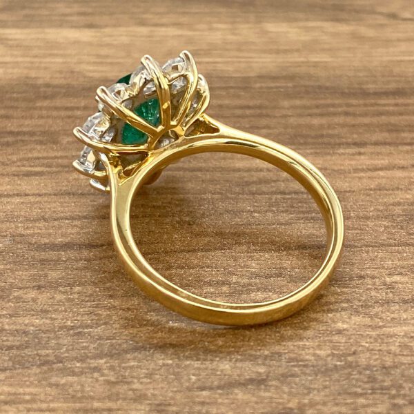 Gold ring with emerald and diamonds.