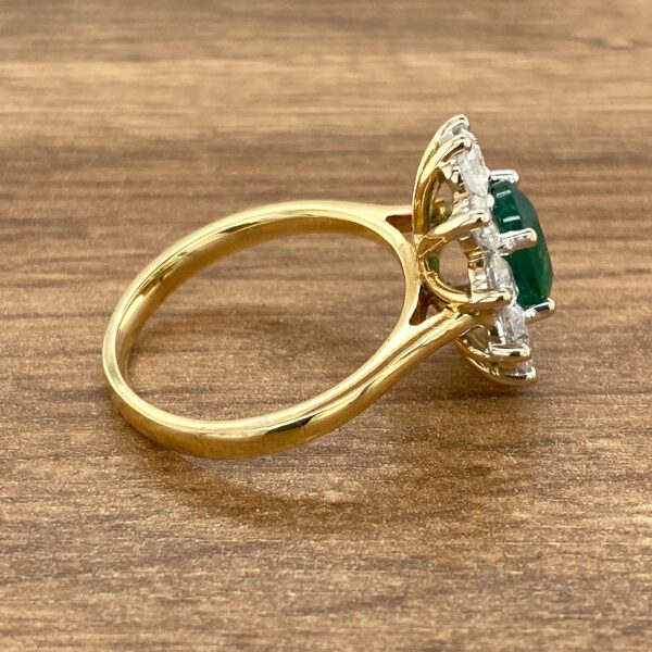 Gold ring with emerald and diamonds.
