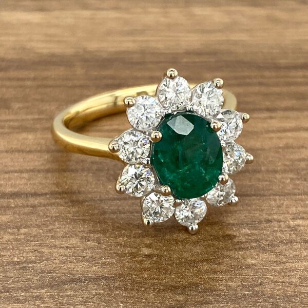 Gold ring with emerald and diamonds.