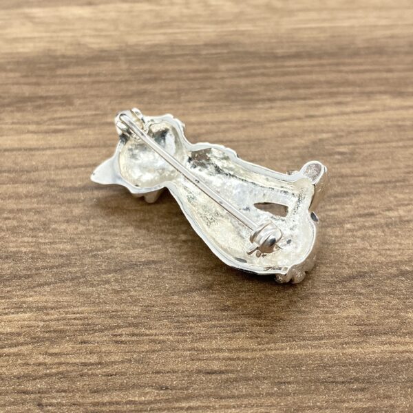 Silver cat brooch with pin on back.