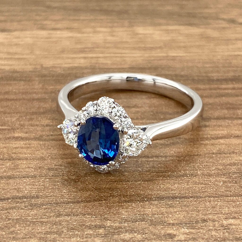 White gold ring with blue sapphire and diamonds.