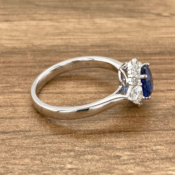 Silver ring with a blue sapphire and diamonds.