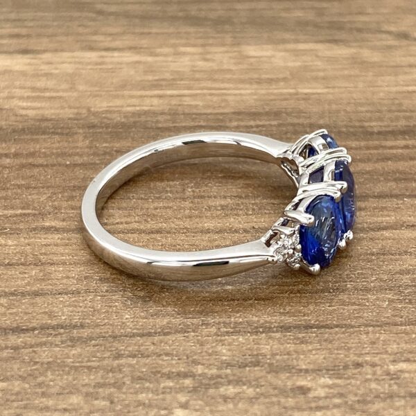 Silver ring with three blue sapphires.