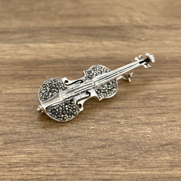 Silver violin brooch with marcasite stones.