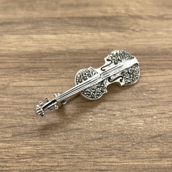 Silver violin brooch with marcasite stones.