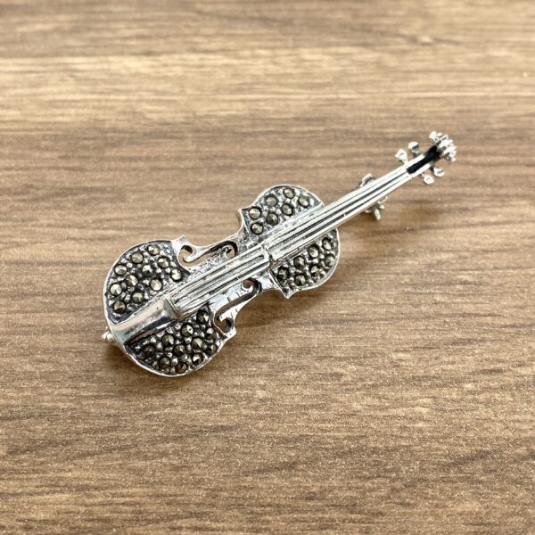 Silver violin brooch with marcasite stones.
