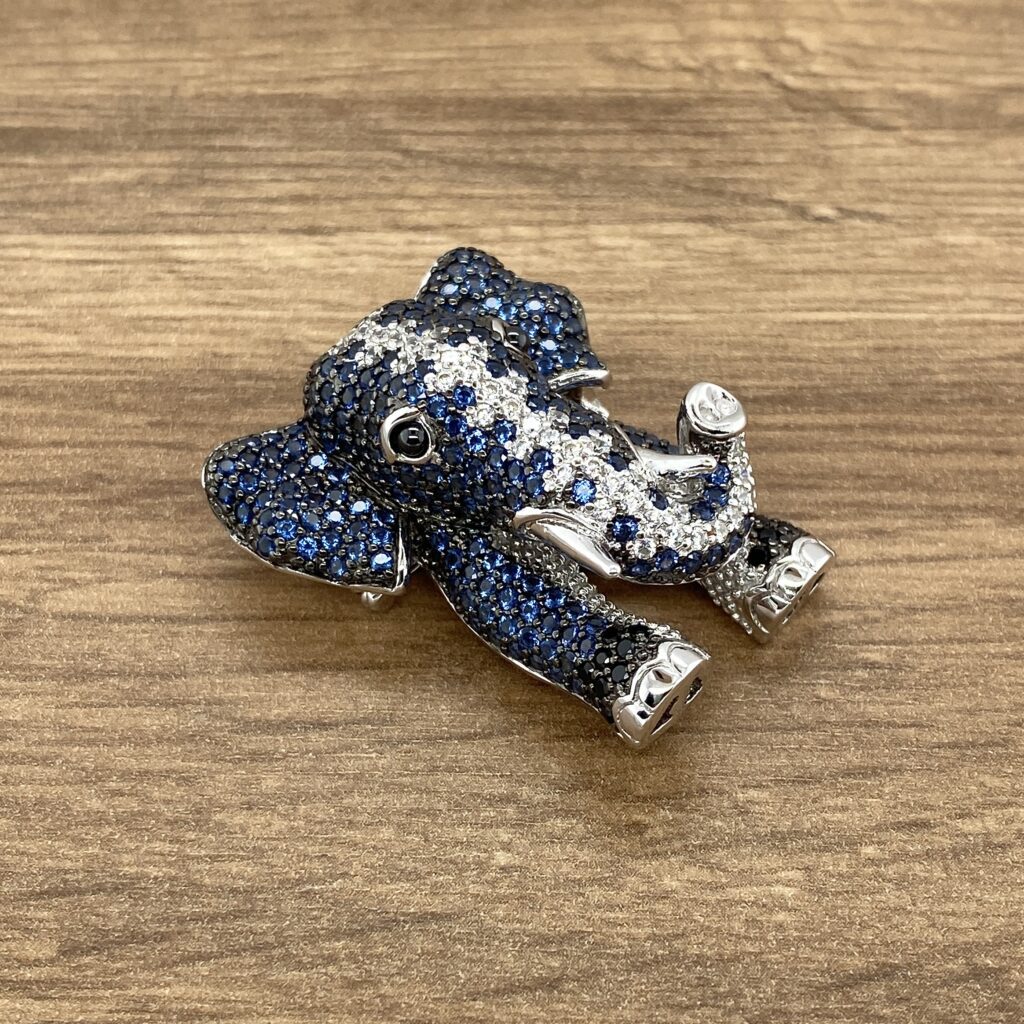 Blue and white jeweled elephant brooch.
