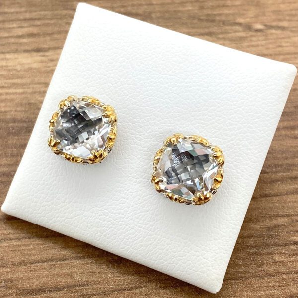 Gold and silver earrings with clear stones.