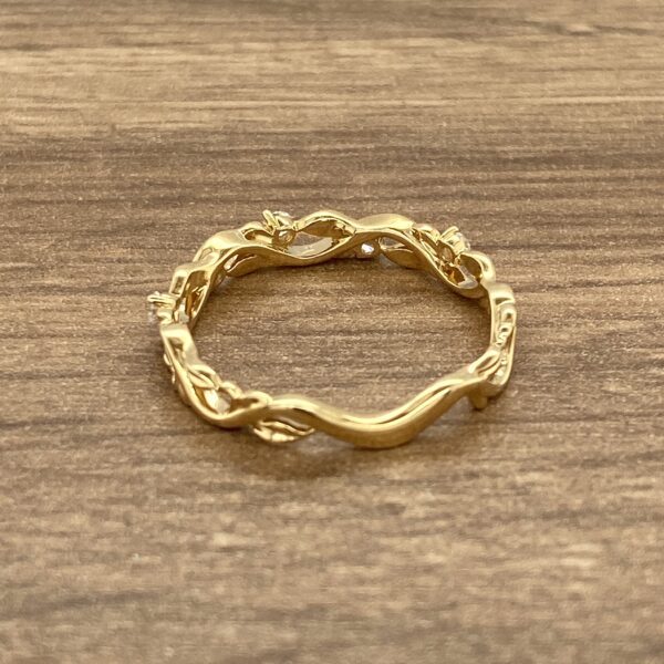 Gold ring with leaf and diamond design.