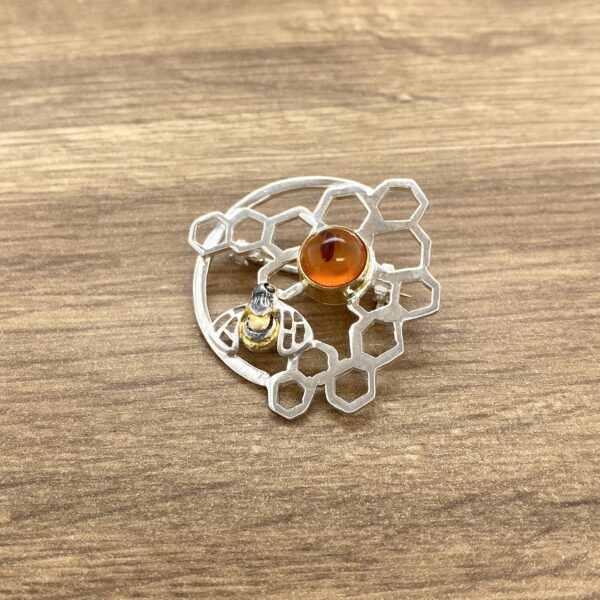 Amber bee brooch honeycomb design.