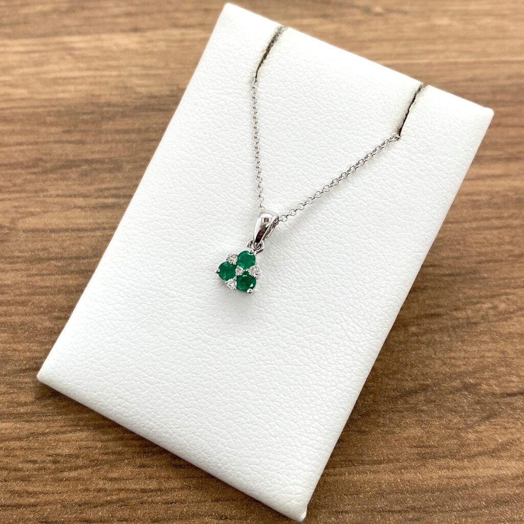 Emerald and diamond pendant necklace.