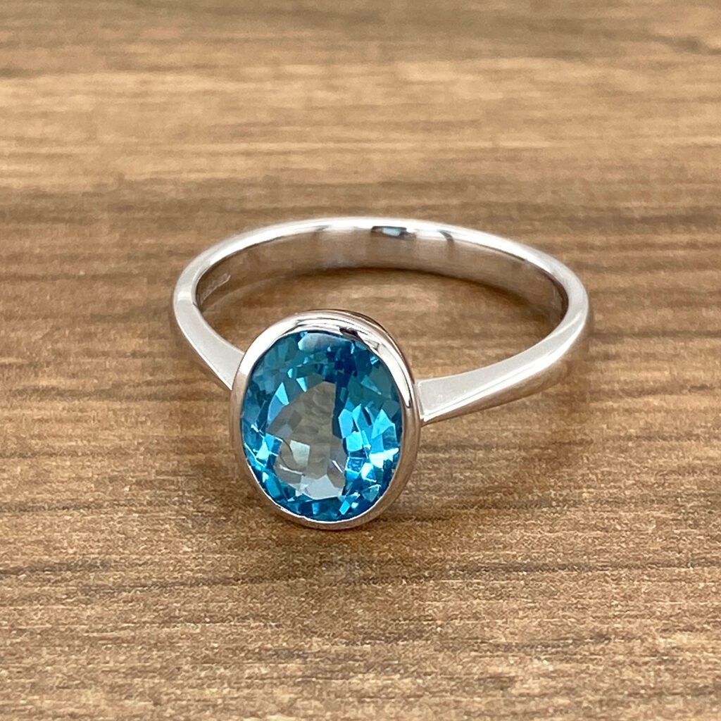 Oval blue topaz solitaire ring.