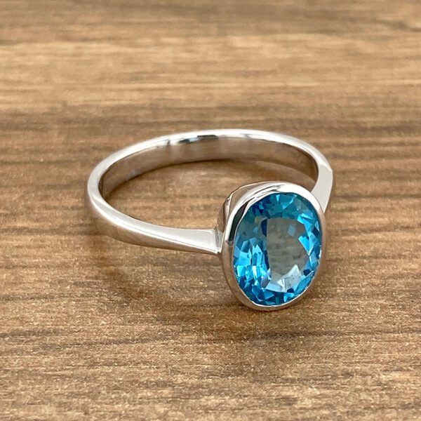 Oval blue topaz solitaire ring.