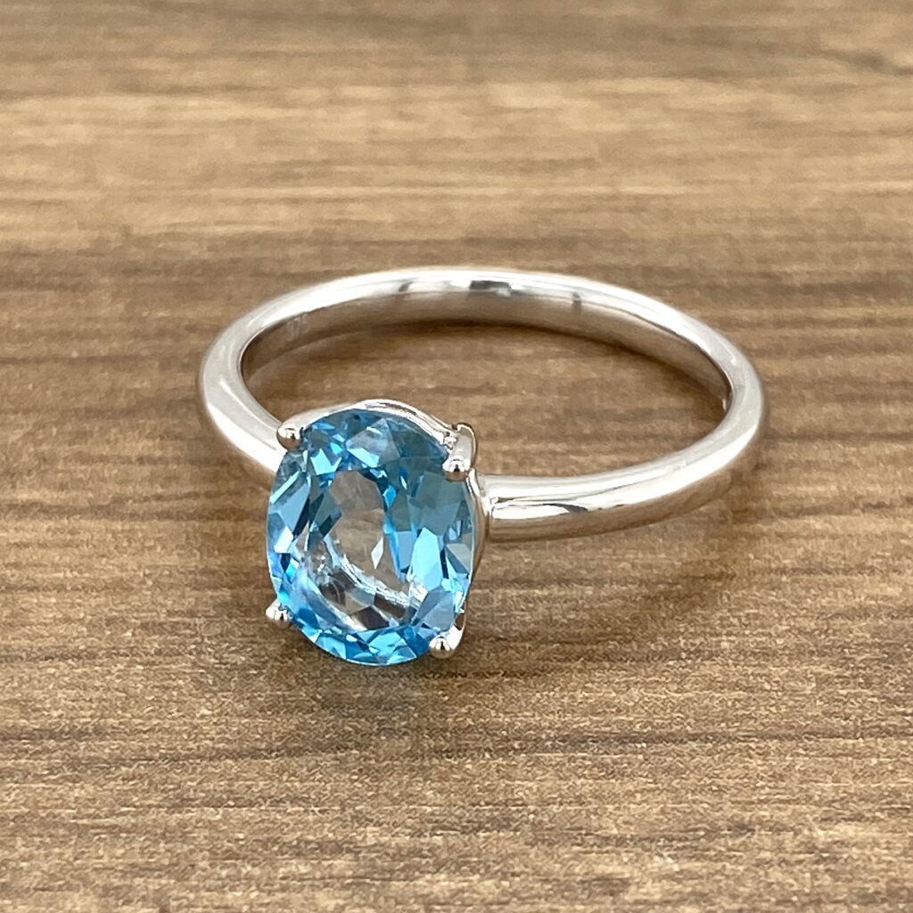 Silver ring with blue topaz gemstone.