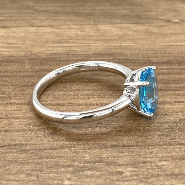 Oval blue topaz solitaire ring.