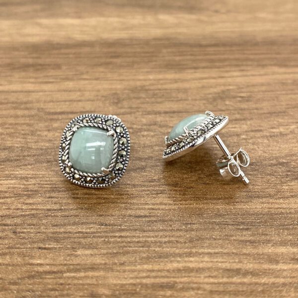 Silver marcasite earrings with green stones.