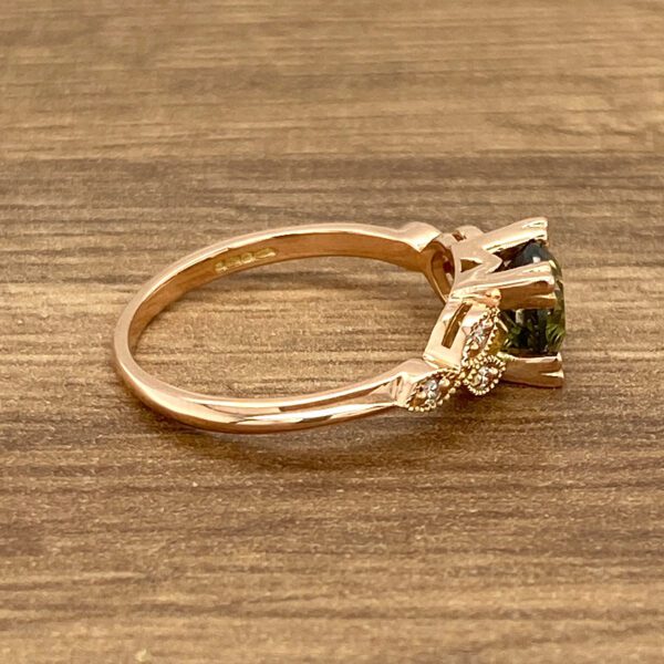Rose gold ring with green gemstone.
