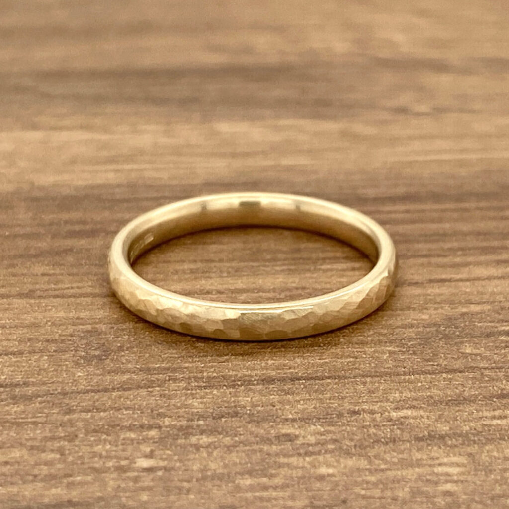 Gold hammered wedding band ring.