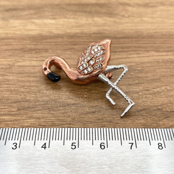Rose gold flamingo brooch with crystals.