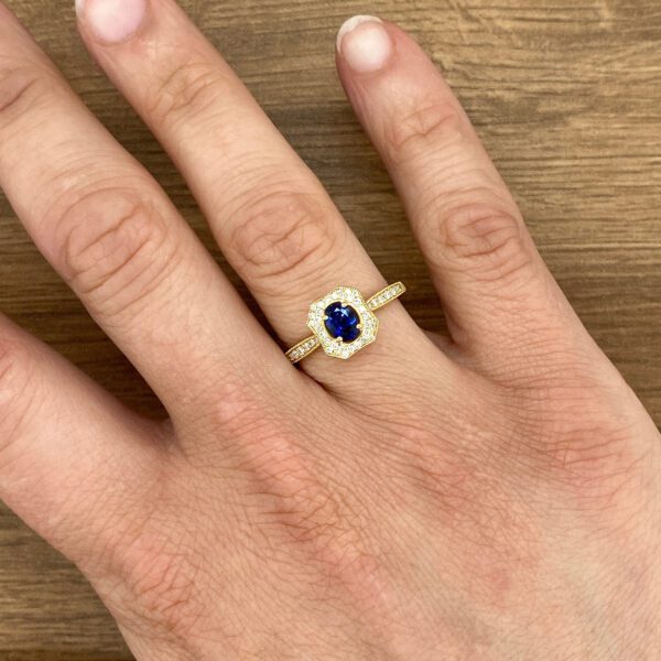 Gold ring with blue sapphire and diamonds.