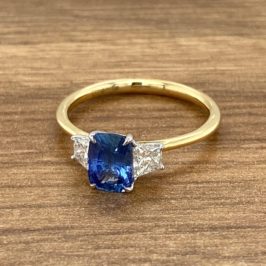 Gold ring with sapphire and diamonds.