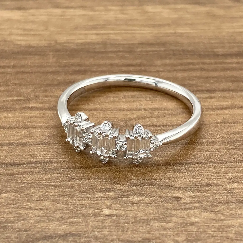 Diamond baguette ring on wood.