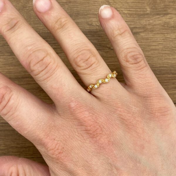 Gold leaf-shaped diamond eternity ring.