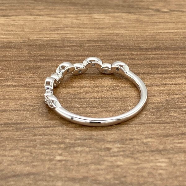 White gold ring with bezel-set diamonds.