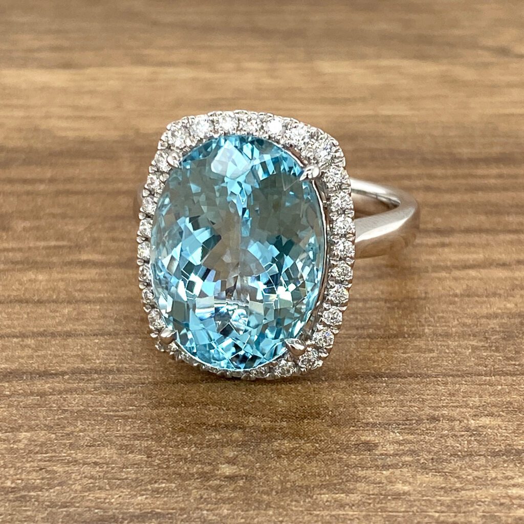 Aquamarine ring with diamond halo.