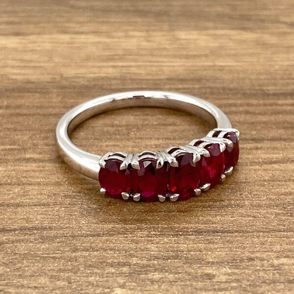 Silver ring with five ruby stones.