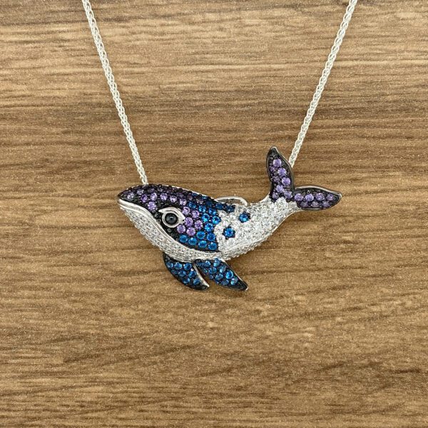 Here's an alt tag for the image: Crystal-encrusted whale necklace.