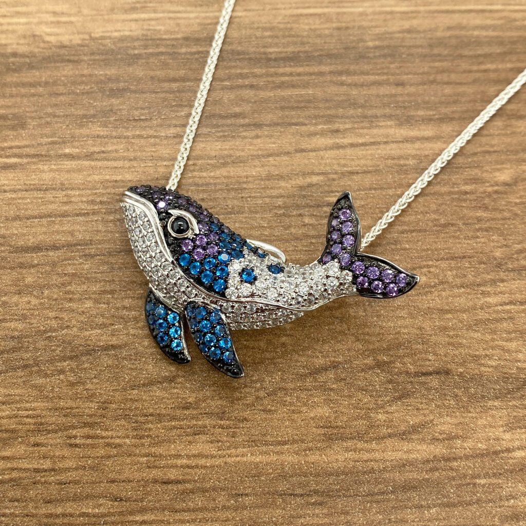 Multicolored gemstone whale necklace.