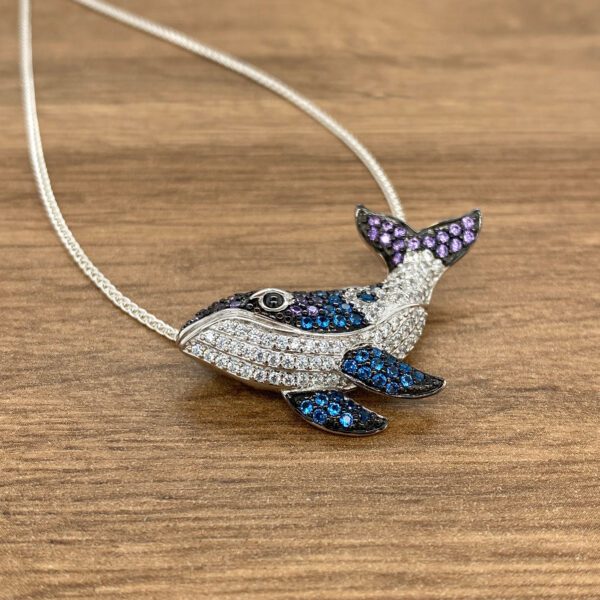 Crystal-encrusted whale pendant necklace.