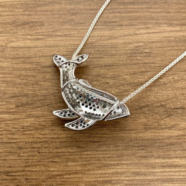 Silver jeweled koi fish necklace.