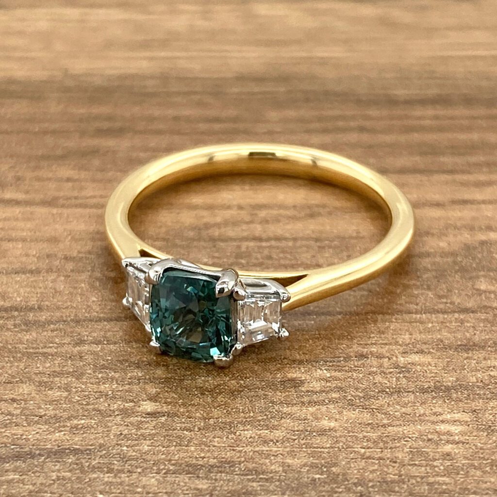 Gold ring with green sapphire and diamonds.
