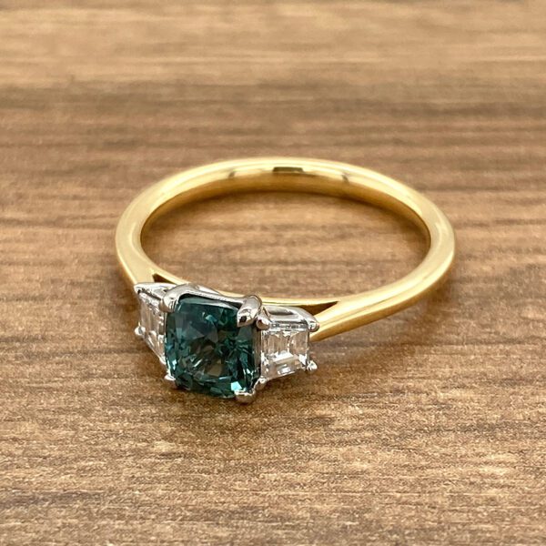 Gold ring with green sapphire and diamonds.