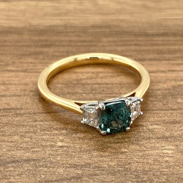 Gold ring with green sapphire and diamonds.