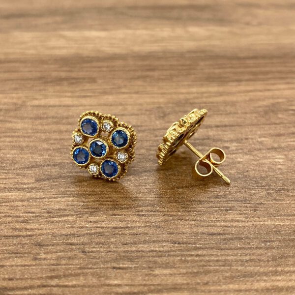 Gold sapphire and diamond stud earrings.