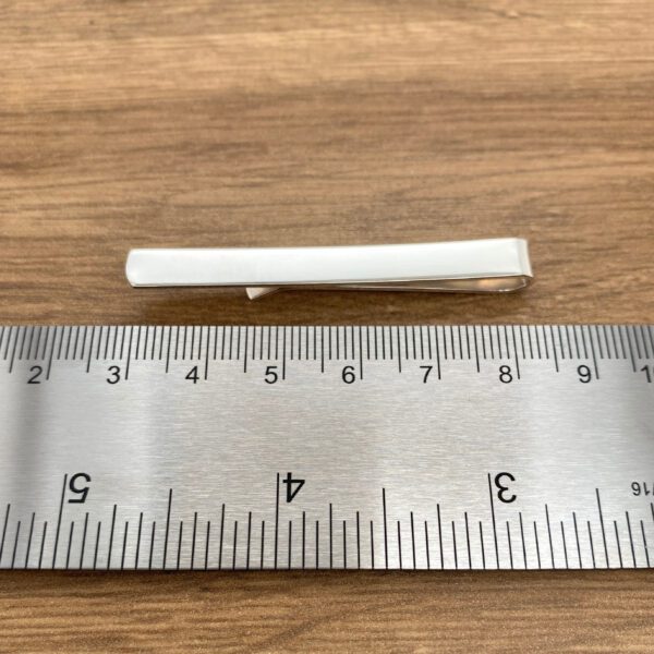 Silver tie bar, approximately 2 inches.