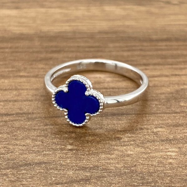 Silver clover ring with blue stone.