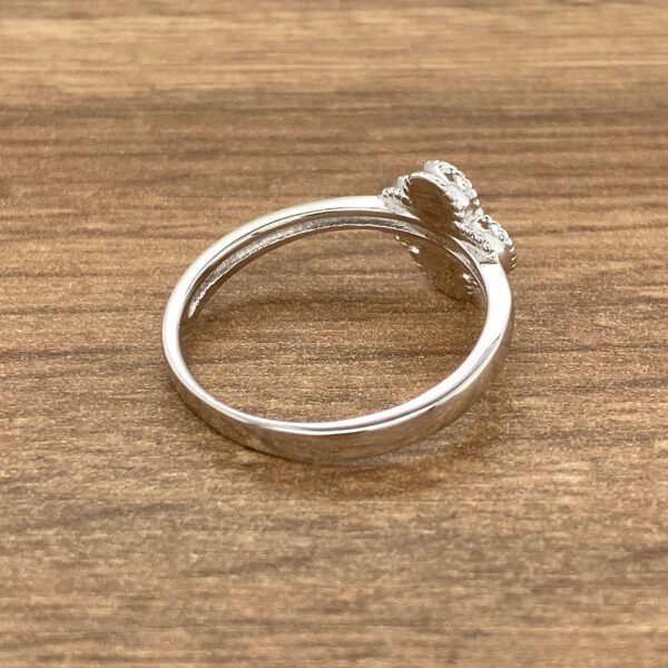 Silver clover ring with small stones.