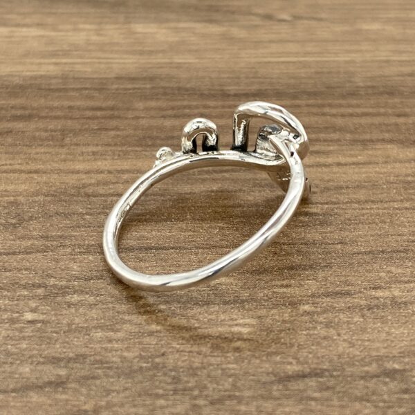 Silver ring with abstract design.
