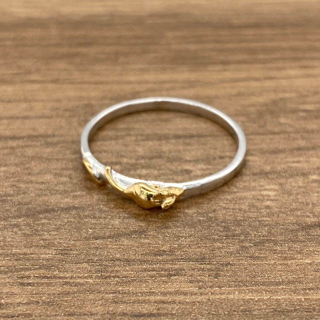Silver ring with gold leaf detail.