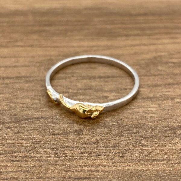 Silver ring with gold leaf detail.