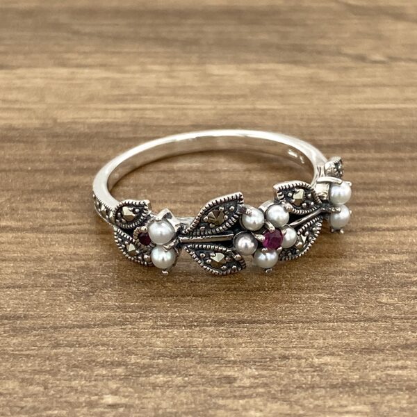 Silver ring with pearls and rubies.