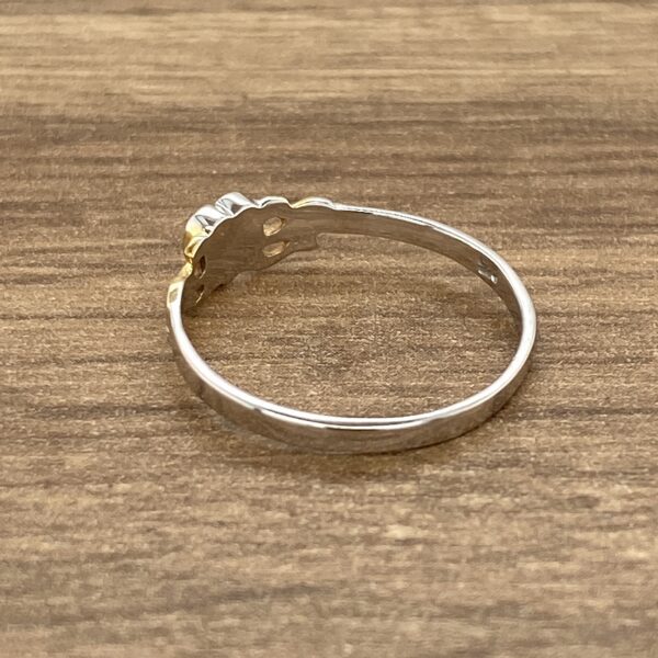 Two-tone ring with floral design.