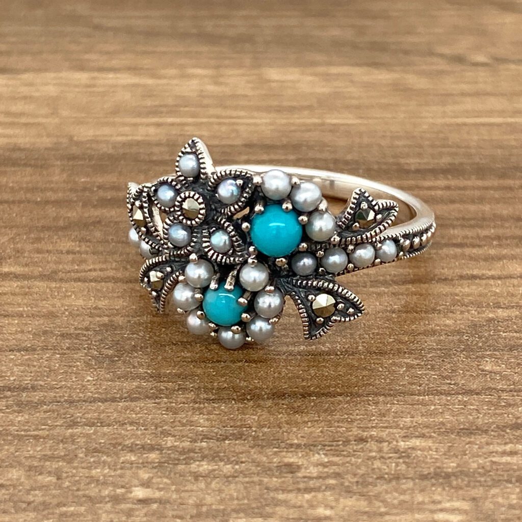 Silver ring with turquoise and pearls.