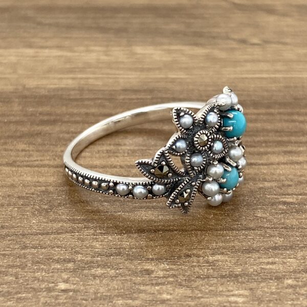 Silver ring with pearls and turquoise.