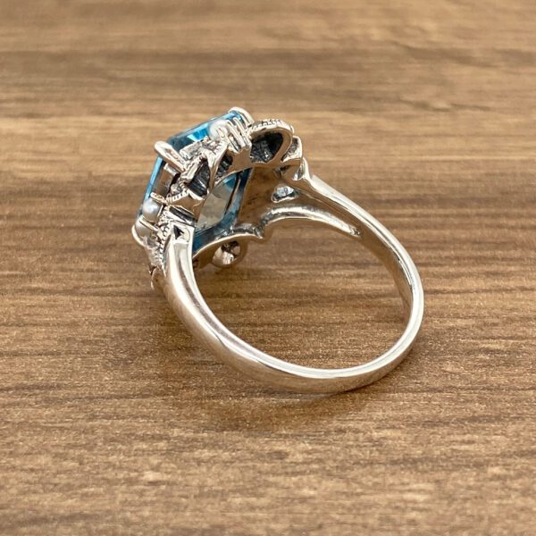 Silver ring with blue gemstone.