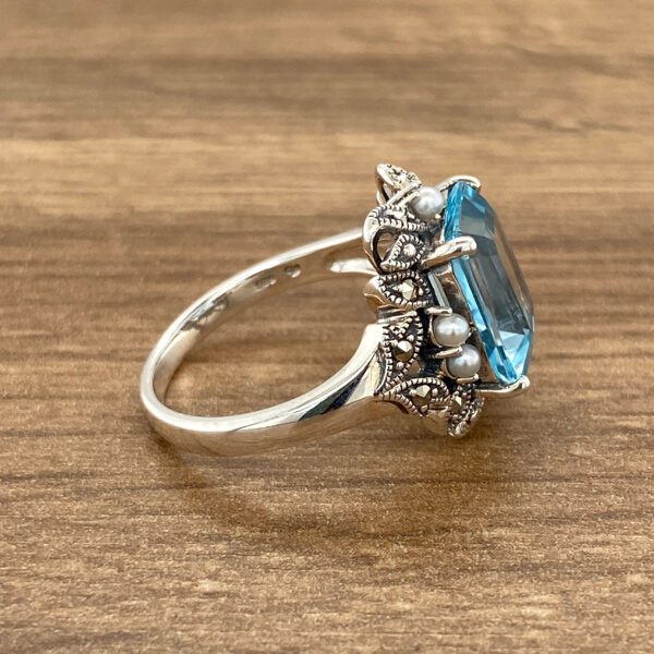 Sterling silver blue topaz ring with pearls.